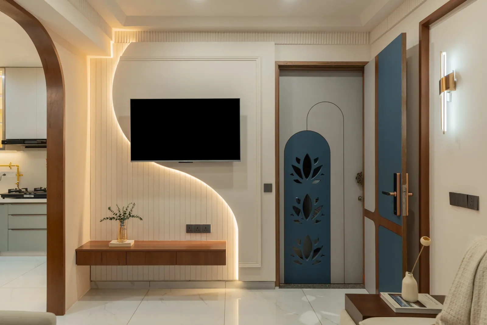 Entrance foyer and TV wall at Anand Nilay, Sarthya West, interior design by Ekaya Design Studio