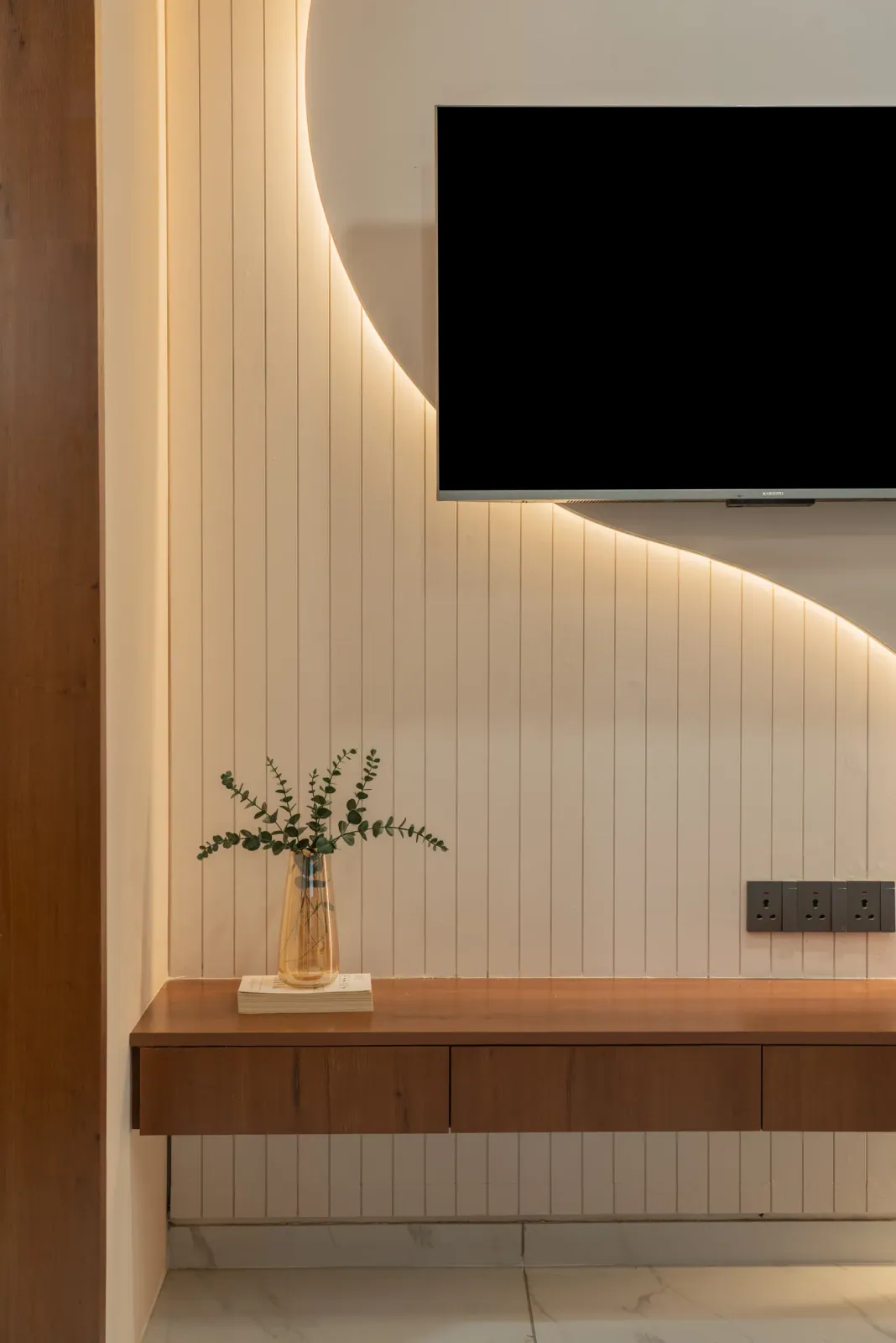 Living room TV wall at Anand Nilay, Sarthya West, interior design by Ekaya Design Studio
