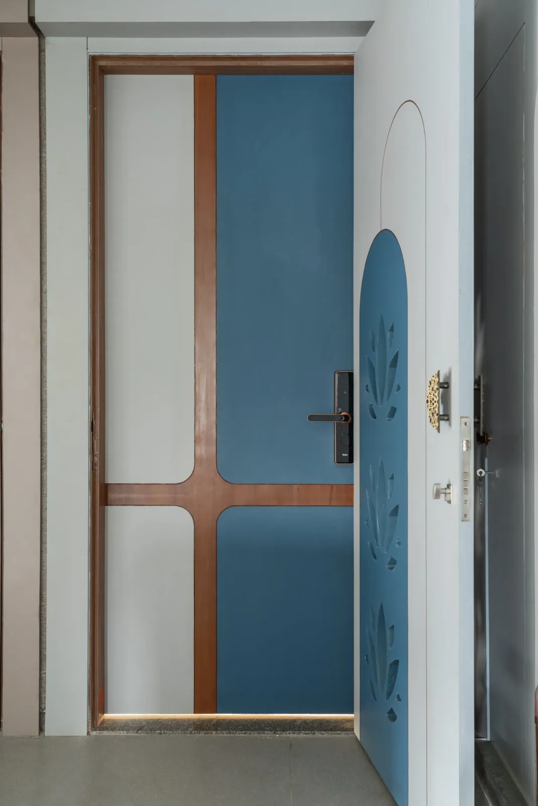 Entrance door at Anand Nilay, Sarthya West, interior design by Ekaya Design Studio