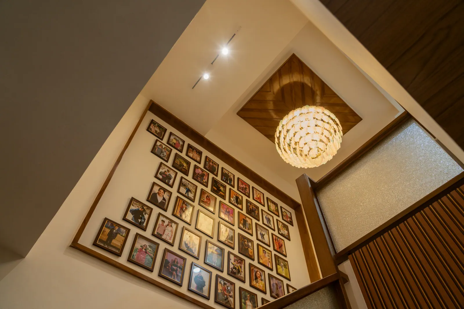 Photo wall and pendant light at Bouganville, interior design by Ekaya Design Studio