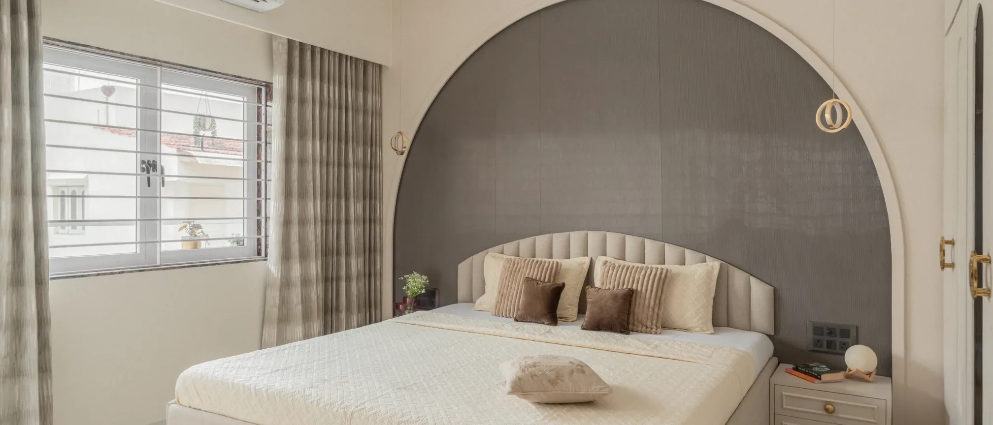 Bedroom with arched headboard at Krishna Park, interior design by Ekaya Design Studio