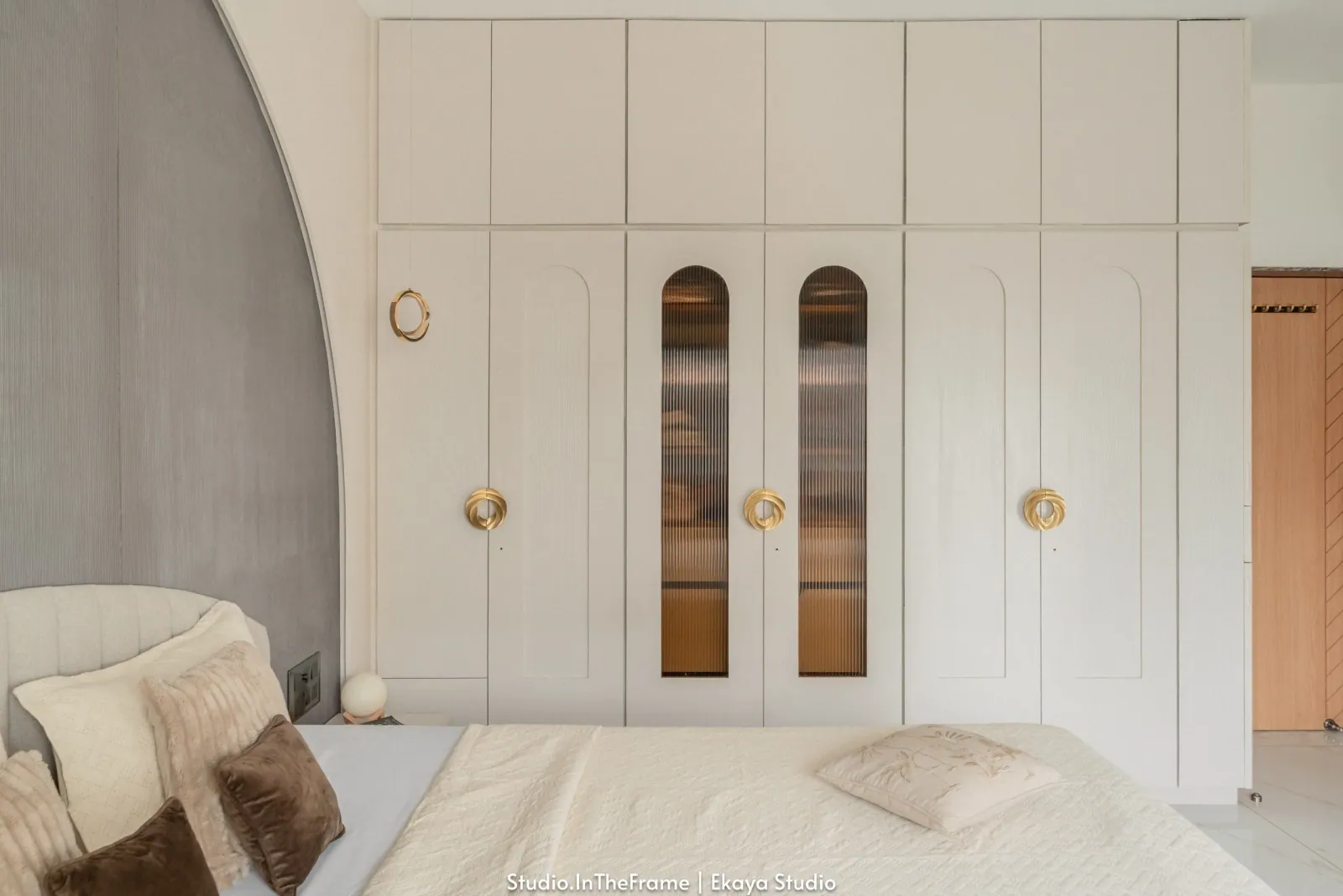 Bedroom with arched headboard at Krishna Park, interior design by Ekaya Design Studio