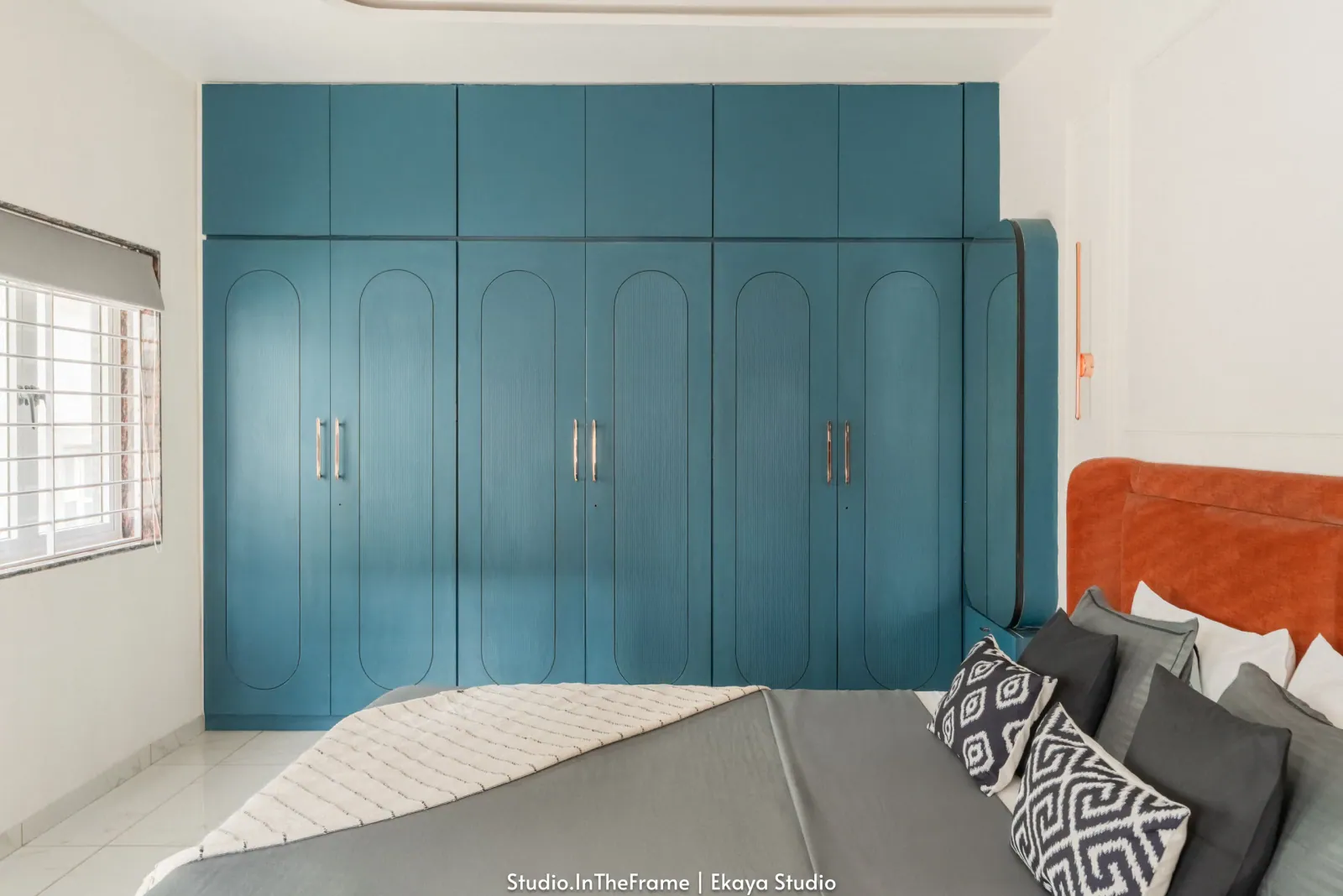 Bedroom with teal wardrobes at Krishna Park, interior design by Ekaya Design Studio