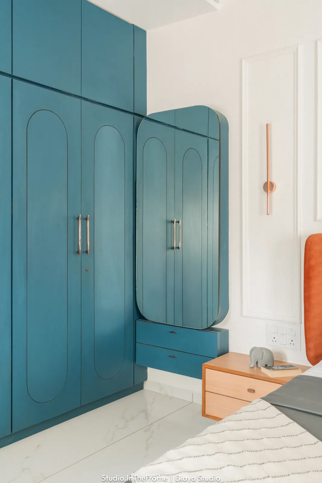 Bedroom with teal wardrobes at Krishna Park, interior design by Ekaya Design Studio
