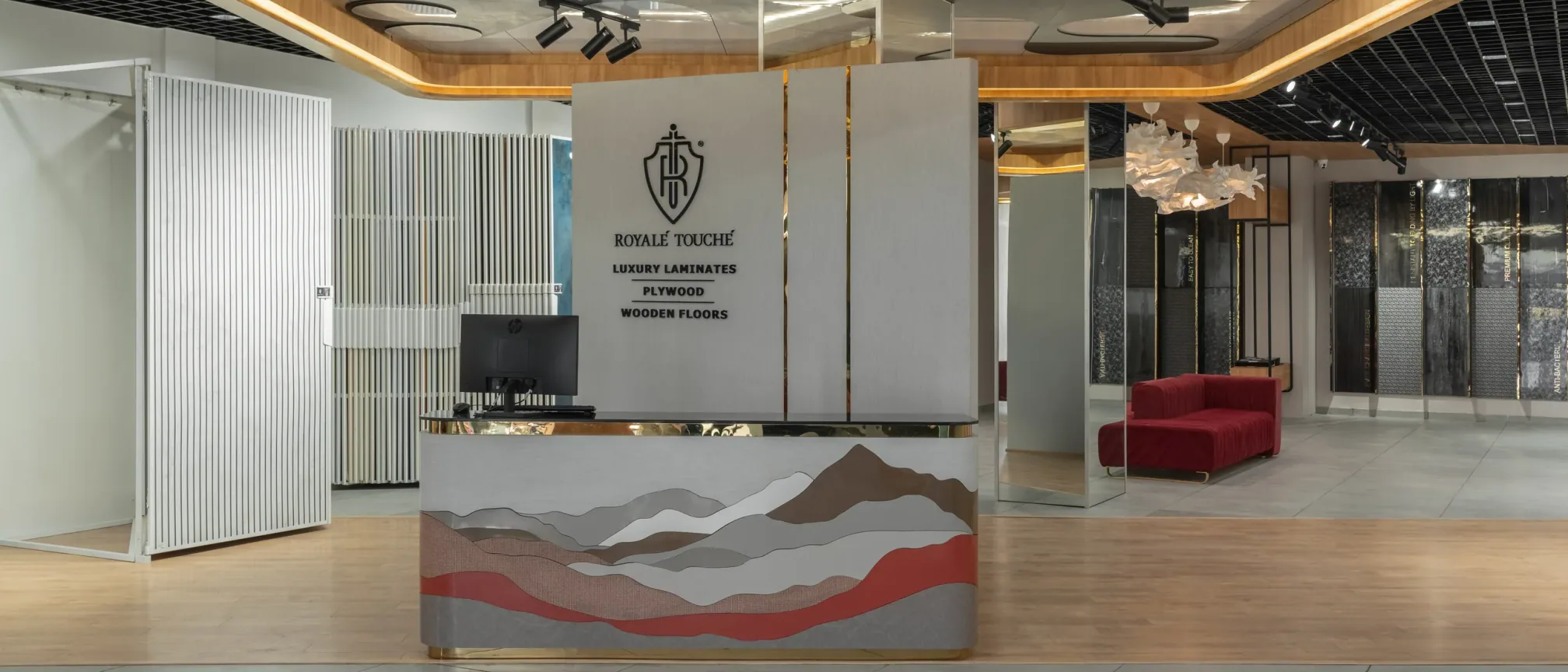 Reception desk at Royale Touche Showroom, Palanpur, interior design by Ekaya Design Studio